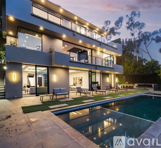 A modern house with a pool in the backyard.