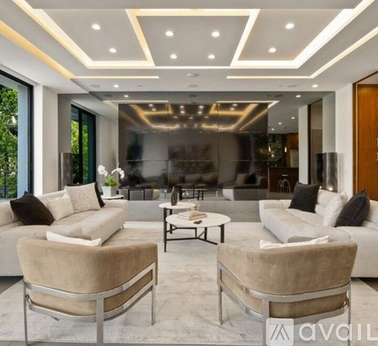 A modern living room with a glass wall and a large window.