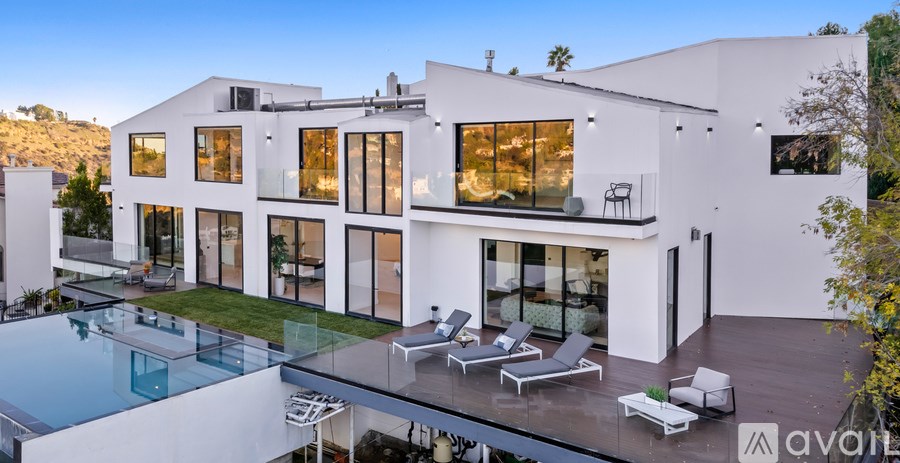 A modern house with a pool in the backyard.
