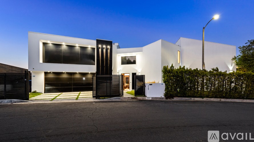 A modern house with a black and white exterior is available for purchase.