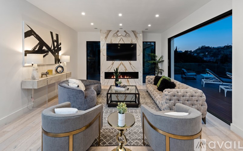 A modern living room with grey and gold furniture.