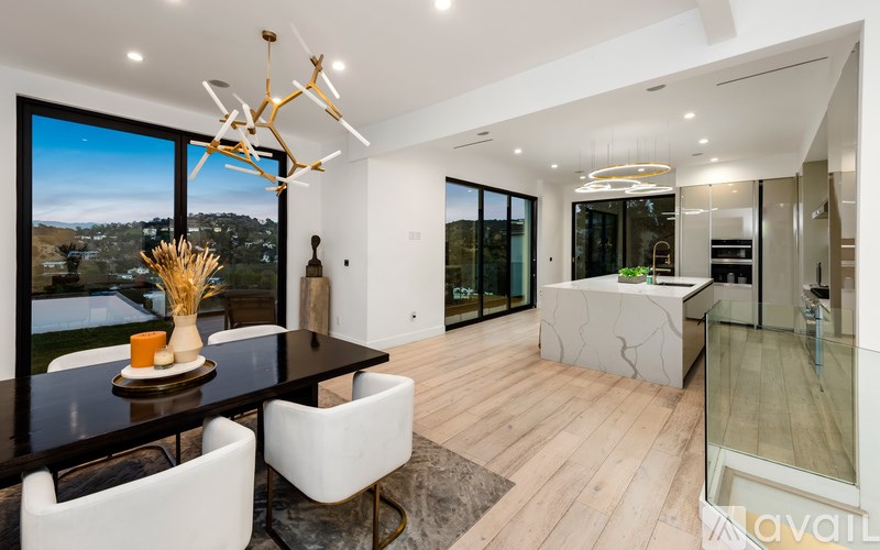 A modern dining room with a view of the outdoors.