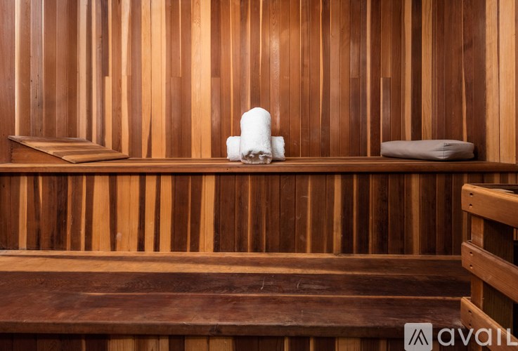 A wooden sauna with towels on the bench.