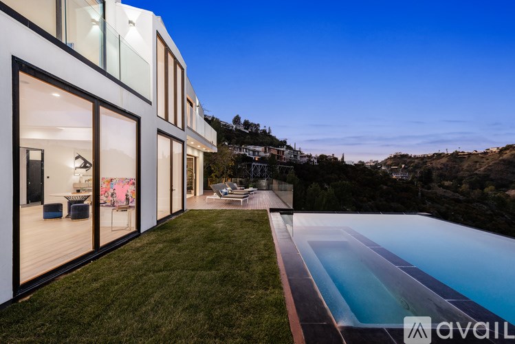A modern house with a pool in the backyard.