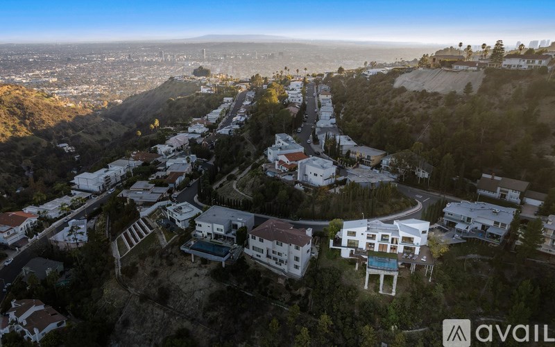 A bird's eye view of a residential area with houses on a hillside.