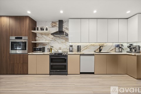 A modern kitchen with wooden cabinets and a marble backsplash.