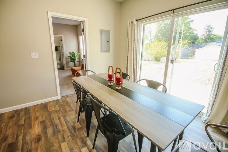 A dining room with a long table and chairs.