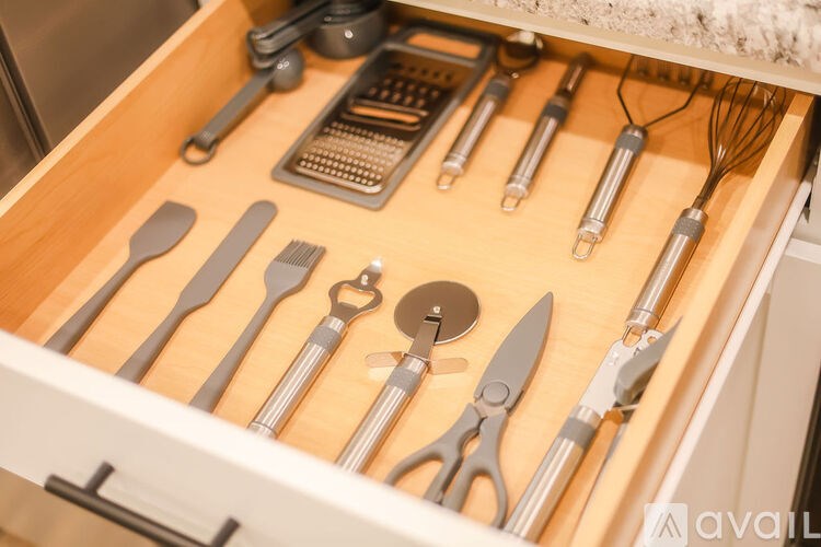 A drawer full of various kitchen utensils.