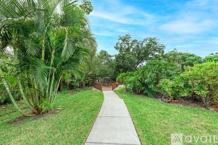 A pathway leads through a lush green garden.