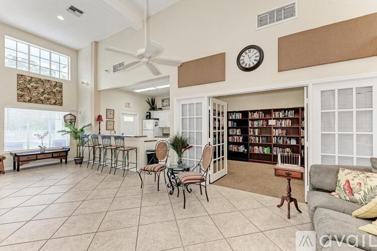 A living room with a bookshelf filled with books.