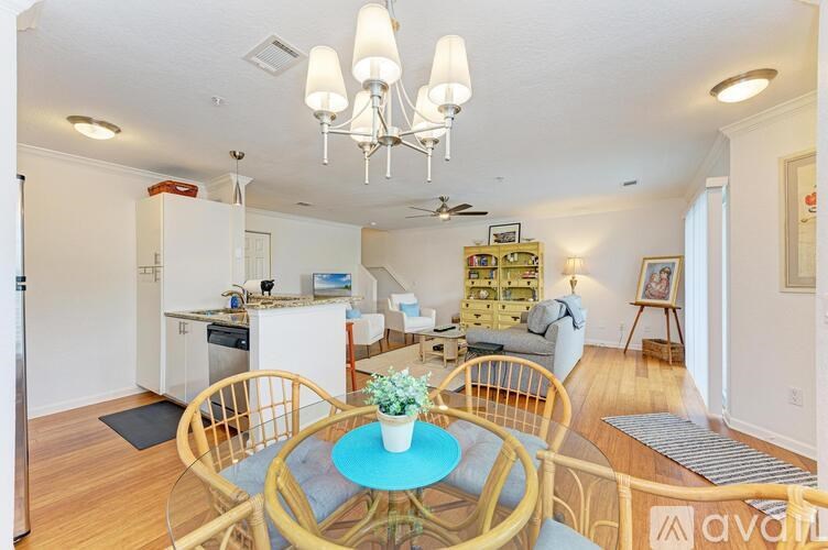 A dining room with a table set for four.