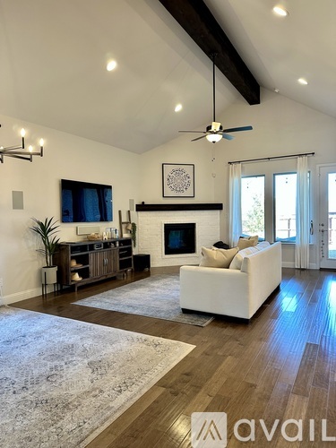 A living room with a fireplace and a white couch.