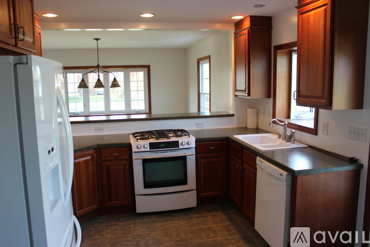 A kitchen with a white fridge, white dishwasher, and a white stove.