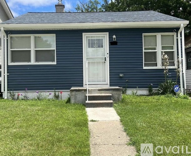 A blue house with a white door and windows.