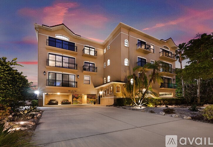 A large, well-lit two-story building with a driveway in front.