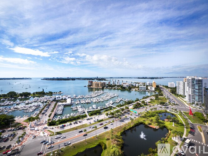 A marina with boats and a city skyline in the background.
