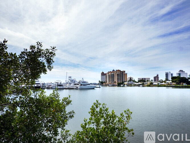 A view of a harbor with boats and buildings in the distance.