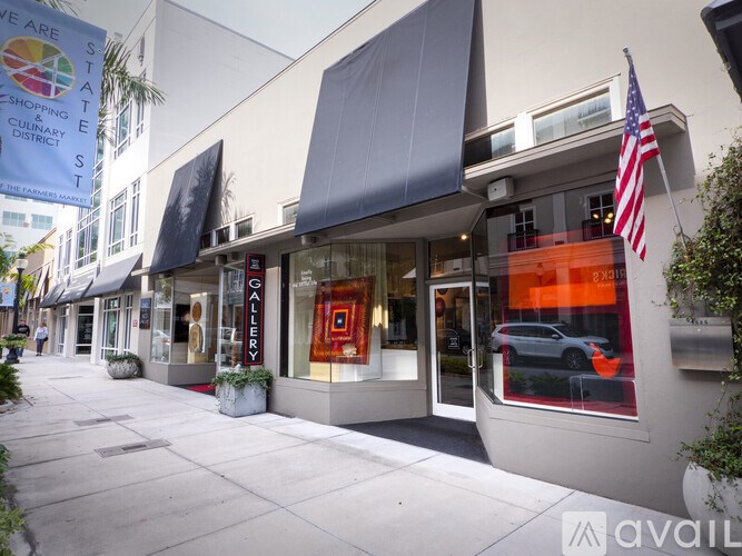 A street view of a State Shopping and Culinary District with a banner hanging from a building.