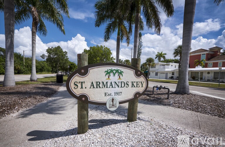 A sign for St. Armands Key with a palm tree in the background.