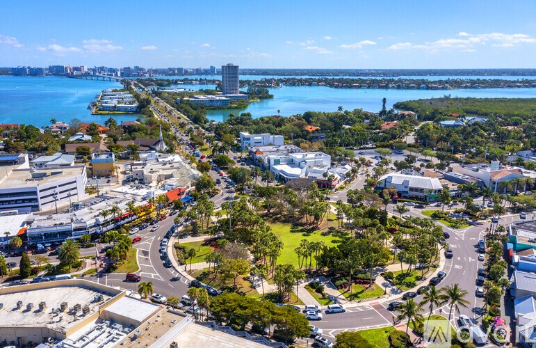 A cityscape with a large body of water in the background.