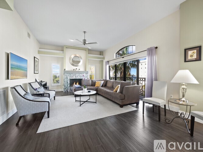 A living room with a fireplace and a painting on the wall.