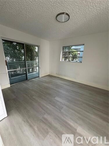 A room with a grey floor and a window.