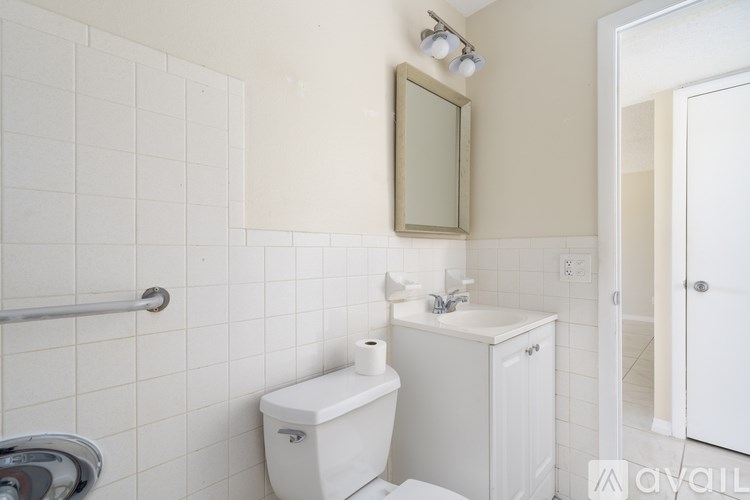 A white toilet and sink in a small bathroom.
