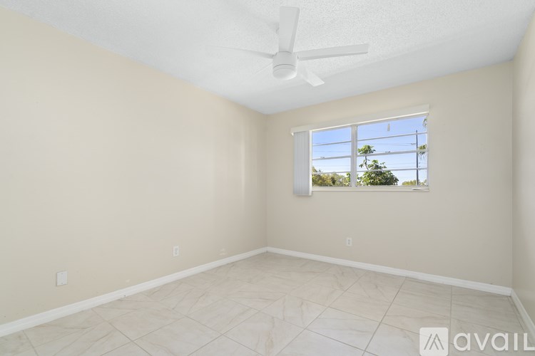 A room with a window and a ceiling fan.