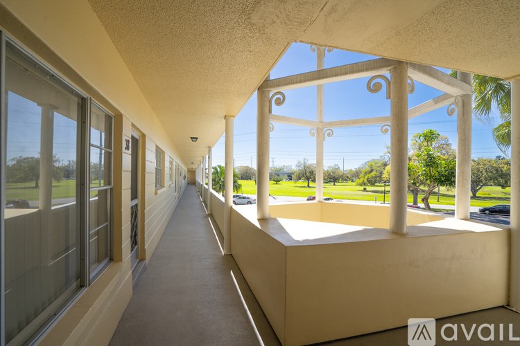 A long hallway with a view of the outside through the windows.
