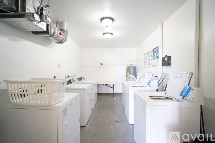 A laundry room with washers and dryers.