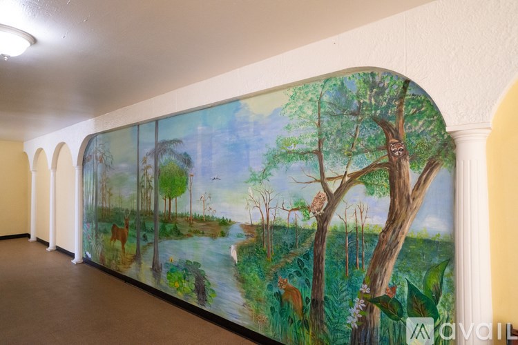 A long mural painting of a forest scene with animals.
