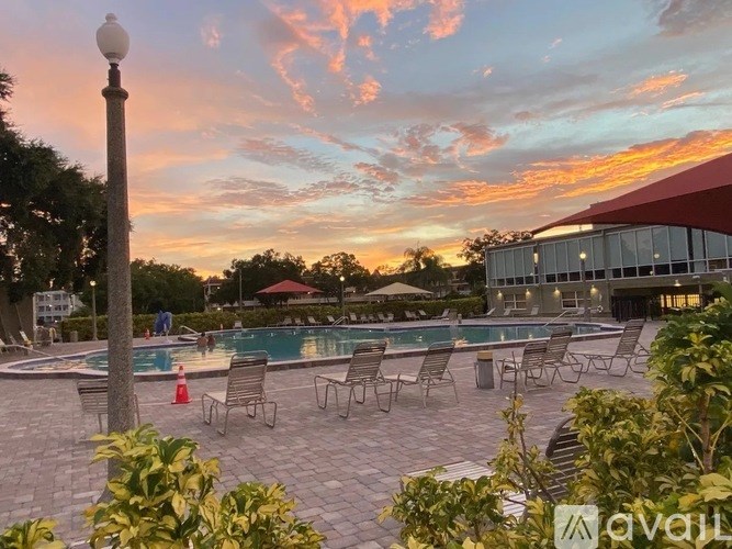 A pool area with chairs and a lamp post is visible.
