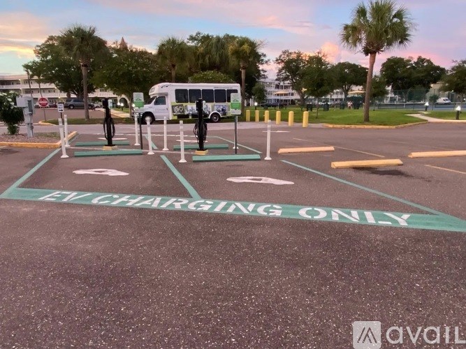 An electric vehicle charging station with a sign that says "EV CHARGING ONLY".
