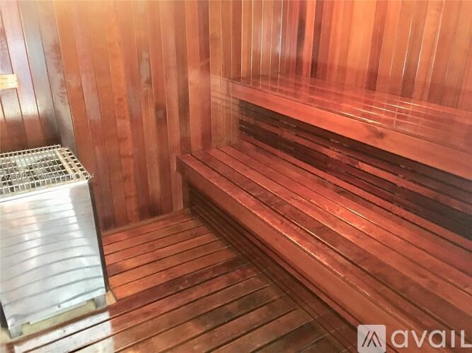 A sauna with wooden benches and a heater on the side.