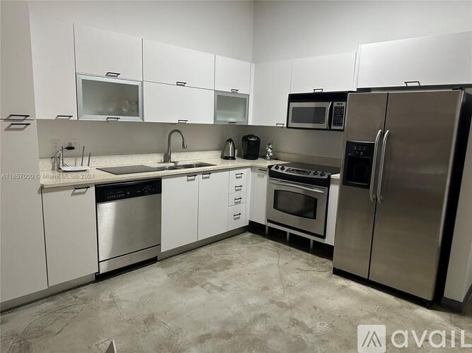 A kitchen with white cabinets and stainless steel appliances.