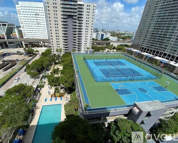 A tennis court is located on the roof of a building.