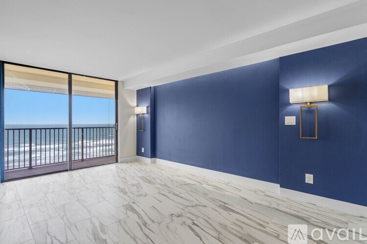A room with a balcony and a marble floor.
