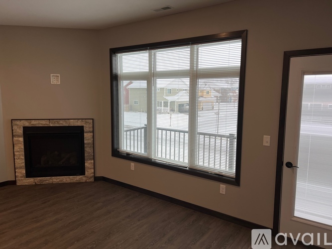 A living room with a fireplace and a sliding glass door.