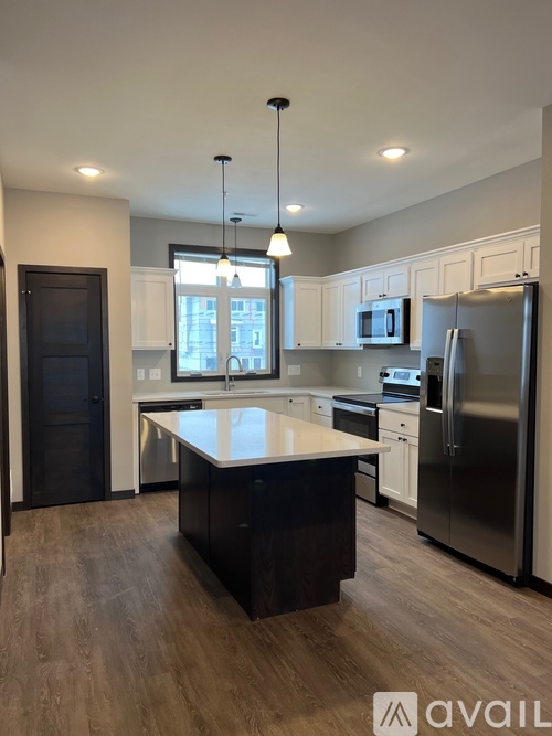 A modern kitchen with a large island in the middle.