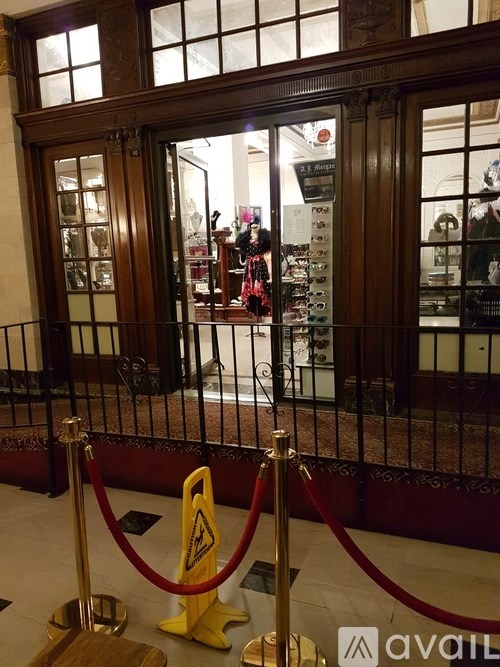 A glass door with a red rope barrier in front of it.