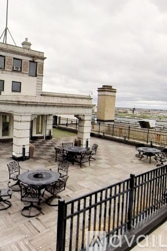 A balcony with a table and chairs overlooking a body of water.