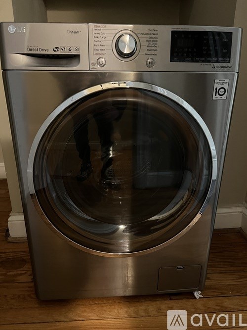 A front-loading washing machine with the door open.