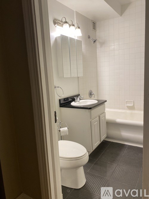 A bathroom with a toilet, sink, and bathtub.