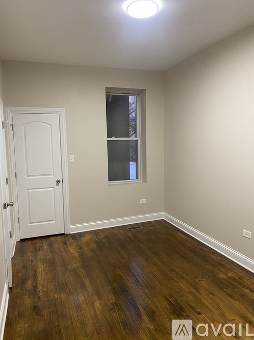 A room with a white door and a window with a white frame.