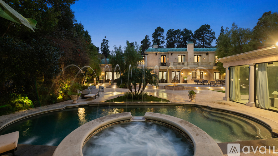 A large house with a pool in the backyard.