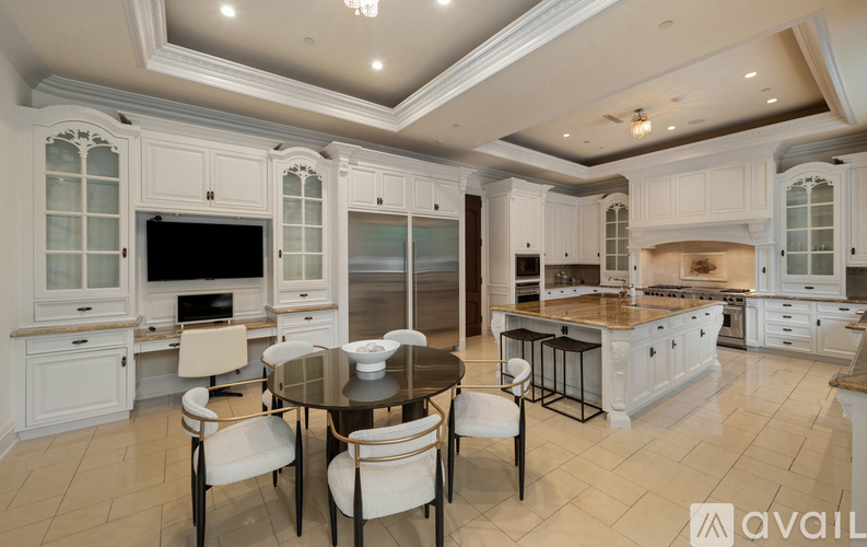 A modern kitchen with a glass table and chairs.