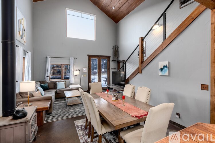A dining room with a wooden table and chairs.