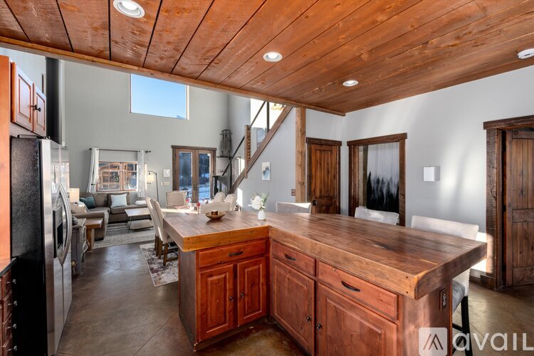 A kitchen with wooden cabinets and a large island.