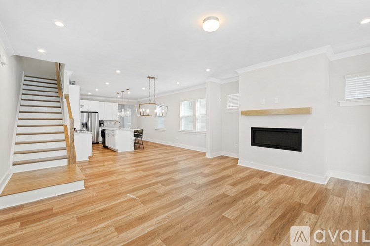 A spacious living room with a fireplace and wooden flooring.