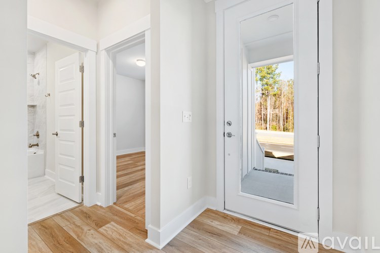 A white door with a glass window is open.